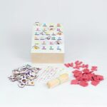 Kit Caixa Alfabeto da Materiais para Brincar, mostrando uma caixa de MDF aberta com diversos materiais de alfabetização, incluindo fichas com figuras, alfabetos em EVA e palitos.