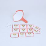 Jogo Imite o Cachorrinho da Materiais para Brincar, com figuras magnéticas de exercícios orofaciais, ossinhos de recompensa e um espelho em forma de boca.